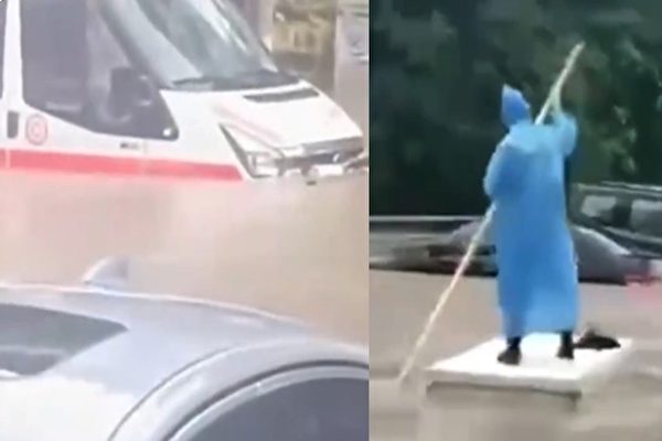 廣西欽州淹水 市民划船前行 救護車擱淺